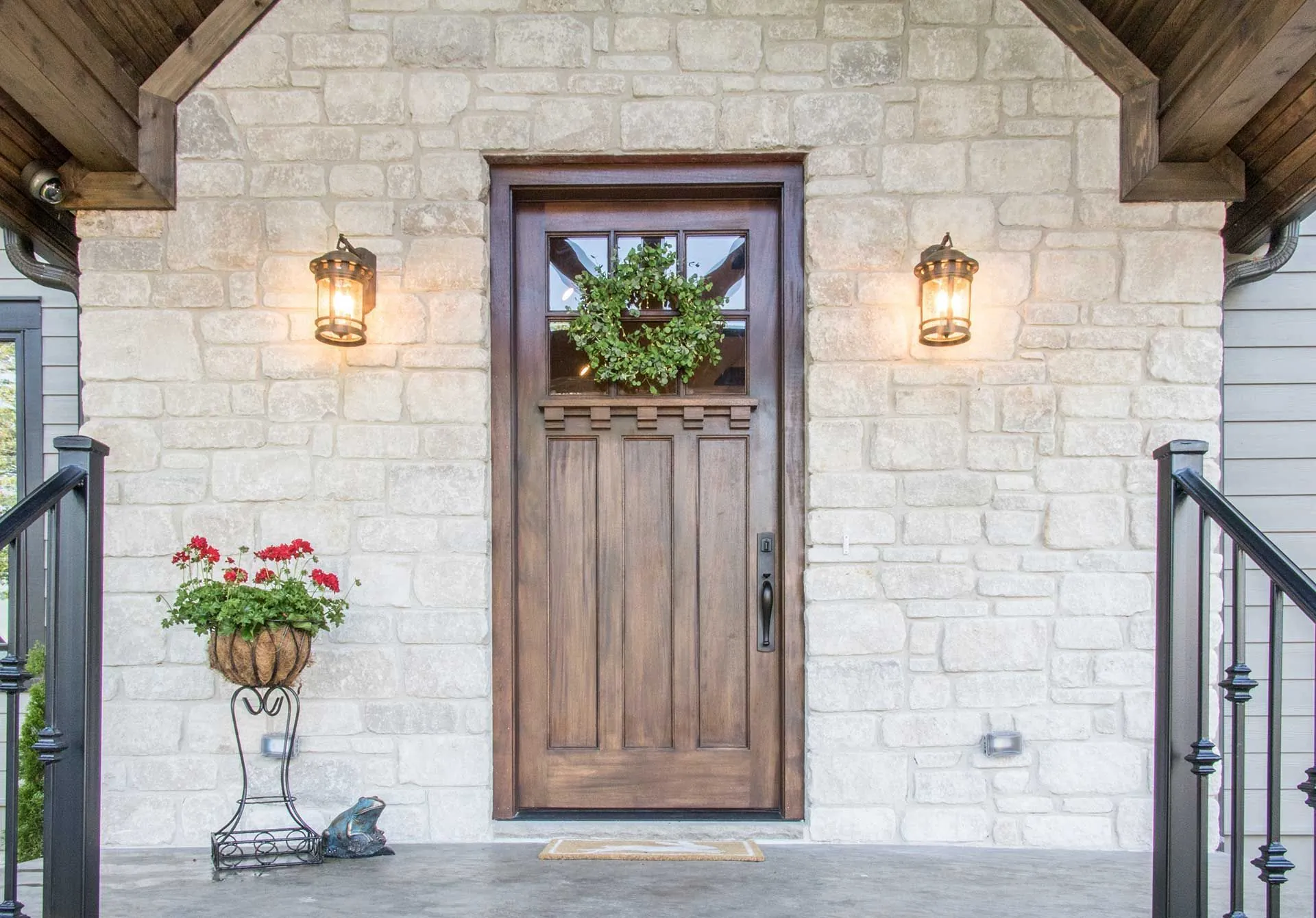 Wooden craftsman door with stone surround